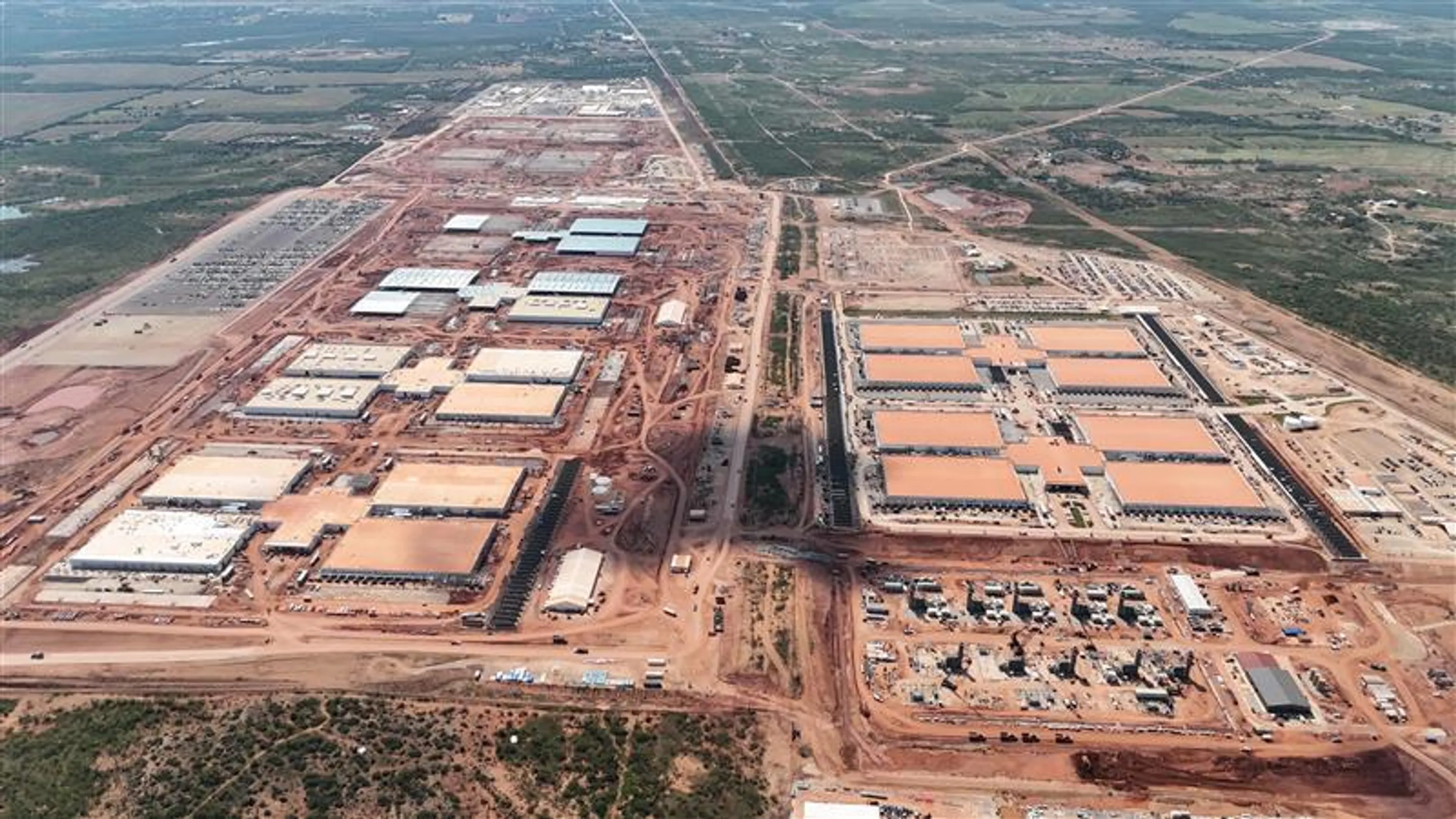 Oblique aerial photograph published by DPR Construction of the Crusoe Abilene data-center campus under construction, showing multiple large building groups, roads and surrounding infrastructure.